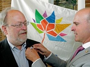 Martin Garber-Conrad receives a pin from Edmonton Centre MP Randy Boisonnault at the Edmonton Community Foundation where celebrations marking the 150th anniversary of Confederation in 2017 kicked off on Thursday, Aug. 4, 2016