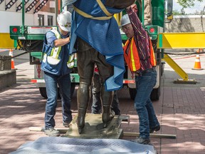 The statue of Wayne Gretzky is removed from its pedestal in front of Rexall Place on Aug.4, 2016. After it is refurbished at the Cochrane studio where is was originally cast, it will be placed at a new location outside Rogers Place.