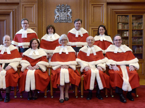The Supreme Court justices pose for a group photo at the Supreme Court, Tuesday Feb.10, 2015 in Ottawa (Adrian Wyld, The Canadian Press)