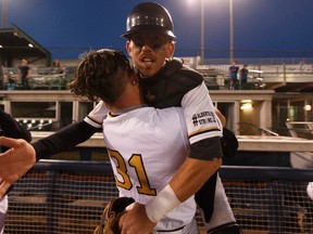 Edmonton's Nathan Finn (left) and Logan Wedgwood celebrate winning Game 4 and their Western Major Baseball League playoff semifinal series between the Edmonton Prospects and the Okotoks Dawgs at Telus Field in Edmonton on Aug. 3, 2016.