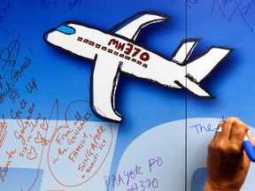 In this March 6, 2016, file photo, well wishes are written on a wall of hope during a remembrance event for the ill fated Malaysia Airlines Flight 370 in Kuala Lumpur, Malaysia. Malaysia has confirmed one of the pilots of Malaysia Airlines Flight 370 had plotted a course on his home flight simulator to the southern Indian Ocean, where the missing jet is believed to have crashed. (AP Photo/Joshua Paul, File)