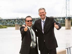 Selkirk Mayor Larry Johannson and Premier Brian Pallister give thumbs up after the province and federal goverment announced the combined funding of $53 million for two new wastewater treatment plants in Selkirk and Gimli. (Brook Jones/Selkirk Journal photo)