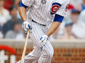 This July 26, 2014, file photo shows Chicago Cubs' Nate Schierholtz watching his home run against the St. Louis Cardinals, in Chicago. (AP Photo/Andrew A. Nelles, File)