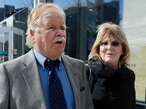 Robert Fitzpatrick, of Charlestown, R.I., walks from federal court in Boston with his wife Jane. Fitzpatrick, a former FBI agent accused of lying during his testimony in the trial of Boston gangster James "Whitey" Bulger, pleaded guilty to perjury and obstruction of justice for lying and overstating his professional accomplishments, including claiming he was the first officer to recover the gun used to assassinate Martin Luther King Jr. in 1968. (AP Photo/Elise Amendola, File)