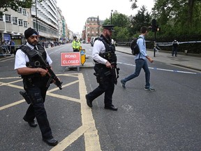 Armed police personnel walk past a crime scene in London's Russell Square on August 4, 2016, following a knife attack in which one woman was killed and five others injured. 
A woman was killed and five people injured in a knife attack in central London Wednesday which police said they are investigating for possible terrorist links. A 19-year-old man was arrested in Russell Square, in the city centre, which was cordoned off after the attack as police swarmed the area.
 / AFP PHOTO / JUSTIN TALLISJUSTIN TALLIS/AFP/Getty Images