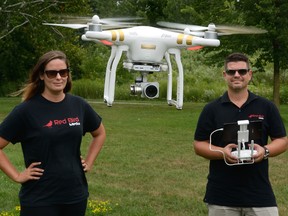 Caitlin Sonik, left, and Matthew Dumas of Red Bird Media fly one of their drones in Gibbons Park on Friday August 5, 2016. (MORRIS LAMONT, The London Free Press)