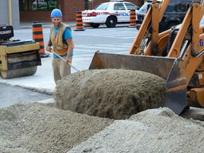 Nuno Silver was one of the workers completing a construction project on Talbot Street at York Street in London, Ontario on Friday August 5, 2016. (MORRIS LAMONT, The London Free Press)