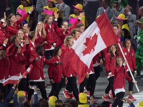 Rosie MacLennan carries the flag as she leads Canada into the opening ceremonies for the 2016 Summer Olympics Friday August 5, 2016 in Rio de Janeiro, Brazil. (THE CANADIAN PRESS/Frank Gunn)