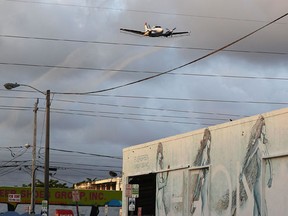 A plane sprays pesticide over the Wynwood neighborhood in the hope of controlling and reducing the number of mosquitos, some of which may be capable of spreading the Zika virus on August 6, 2016 in Miami, Florida. This is the second round of aerial spraying in the area as the county continues to try and prevent the Zika virus from spreading. The CDC has advised pregnant women to avoid the area.  (Joe Raedle/Getty Images)
