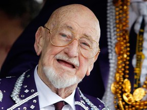 FILE - In this March 8, 2011 file photo, Musician Pete Fountain tosses beads to a reveler from a float as his Half-Fast Walking Club marches down St. Charles Avenue in New Orleans on Mardi Gras Day.  Fountain, whose recording of "Just a Closer Walk With Thee" became the unofficial anthem for traditional New Orleans jazz, has died. He was 86. Fountain's son-in-law and manager Benny Harrell said Fountain died Saturday, Aug. 6, 2016 of heart failure. He had been in hospice care in New Orleans.
(AP Photo/Patrick Semansky)