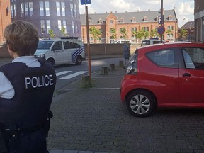 A photo taken with a mobile phone on August 6, 2016, shows a police officer standing guard close to a police building in the southern Belgian city of Charleroi following a machete attack.  Two policewomen were wounded in Charleroi by a machete-wielding man who shouted "Allahu akbar" (God is the greatest), local police said. The attacker was shot and injured, they said on Twitter.
(AFP PHOTO / BELGA AND Belga / FRED DUBOIS / Belgium OUTFRED DUBOIS/AFP/Getty Images)