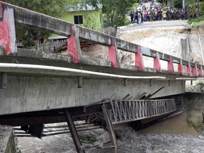 A bridge knocked down by Hurricane Earl at the Arroyito neighborhood in the Melchor de Mencos municipality, Peten departament, 587 km northeast of Guatemala City, on August 4, 2016. Hurricane Earl was downgraded to a tropical storm Thursday after hitting Central America with 130 kilometer (80 mile) per hour winds, but fears of flooding lingered as heavy rain lashed the region. (AFP PHOTO / JOHAN ORDONEZJOHAN ORDONEZ/AFP/Getty Images)