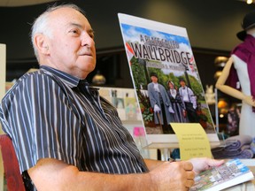 Alex McNaught, author of A Place Called Wallbridge holds a copy of his book on his lap during a book signing event at Chapters on Saturday August 6, 2016 in Belleville, Ont. Tim Miller/Belleville Intelligencer/Postmedia Network