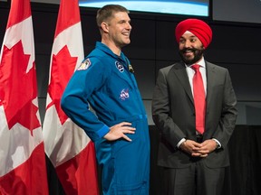 Minister of Innovation, Science and Economic Development Navdeep Bains shares a laugh with Canadian astronaut Jeremy Hansen during an announcement at the Canadian Space Agency, in St-Hubert, Que., on Thursday, Jan. 7, 2016. THE CANADIAN PRESS/Paul Chiasson