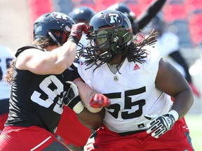 Redblacks offensive lineman SirVincent Rogers (right) battles Connor Williams during a practice earlier this season. (Jean Levac, Postmedia Network)