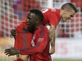 Toronto FC's Jozy Altidore (left) celebrates his goal with Sebastian Giovinco against the New England Revolution during second half MLS action in Toronto on Saturday, Aug. 6, 2016. (Chris Young/The Canadian Press)