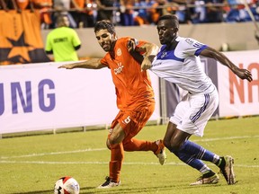 FC Edmonton striker Tomi Ameobi, right, battles for the ball with Puerto Rico FC defender Ramon Soria in North American Soccer League play Saturday in Puerto Rico. Ameobi scored the only goal of the game in a 1-0 win for FC Edmonton.