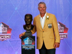Brett Favre poses with a bust of himself during an induction ceremony at the Pro Football Hall of Fame in Canton, Ohio, on Saturday, Aug. 6, 2016. (Gene J. Puskar/AP Photo)