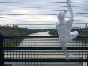 Dummies posed scaling the west-side of the High Level Bridge suicide barrier mysteriously appeared there Sunday morning. It's unclear why or what they mean.