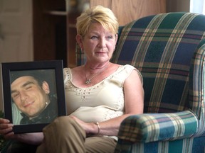 Sandra Hallam holds a photo of her son, Wesley. (PHOTO: Canadian Press)