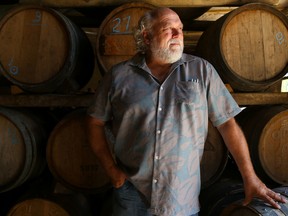 Peter Bradford stands in front of a rack of barrels at his shop on Sunday August 7, 2016 in Picton, Ont. The co-owner of Canadian Vinegar Cellars is one of only a handful of practicing coopers left in Canada. Tim Miller/Belleville Intelligencer/Postmedia Network