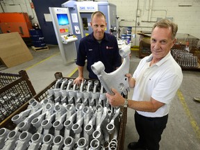 Bob Ramsden, president of Ramsden Industries, right, with his son, general manager Andrew Ramsden, in their London plant on Oakland Avenue, which employs about 75 people and is in the midst of a $6.1 million overhaul that will help it compete globally. (MORRIS LAMONT, The London Free Press)