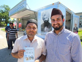 Abdul Razzaqfraz (left) and Imam Zulfiqar Ali stand outside a travelling Muslim display and information trailer in Winnipeg, Man. Sunday August 07, 2016. (Brian Donogh/Winnipeg Sun/Postmedia Network)