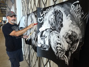Artist Andrew Gillet works on paintings of the Tragically Hip at his Covent Garden Market store. Gillet will be speed-painting the posters in front of Budweiser Gardens before the storied band?s concert Monday night. (MORRIS LAMONT, The London Free Press)