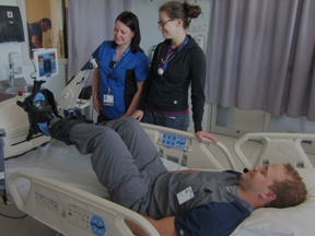 Physiotherapists Josée Lamontagne (left) and Rachel Goard supervised while Respiratory Therapy student Patrick Lapointe demonstrated the specially-designed bicycle at the Ottawa General Campus ICU. (COURTESY OF THE OTTAWA HOSPITAL)