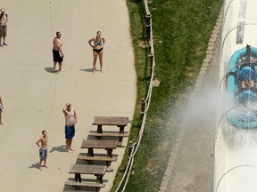 In this July 9, 2014 file photo, riders are propelled by jets of water as they go over a hump while riding a water slide called "Verruckt" at Schlitterbahn Waterpark in Kansas City, Kan. A 12-year-old boy died Sunday, Aug. 7, 2016, on the Kansas water slide that is billed as the world's largest, according to officials. Kansas City, Kansas, police spokesman Officer Cameron Morgan said the boy died at the Schlitterbahn Waterpark, which is located about 15 miles west of downtown Kansas City, Missouri. Schlitterbahn spokeswoman Winter Prosapio said the child died on one of the park's main attractions, Verruckt, a 168-foot-tall water slide that has 264 stairs leading to the top. (AP Photo/Charlie Riedel, File)