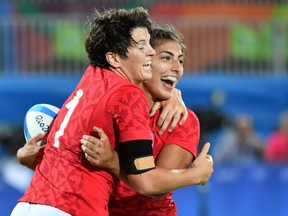 Canada's Brittany Benn (L) and Canada's Bianca Farella celebrate in the womens rugby sevens quarter-final match between Canada and France during the Rio 2016 Olympic Games at Deodoro Stadium in Rio de Janeiro on August 7, 2016. / GUYOTPASCAL GUYOT/Getty Images