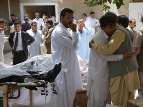 Pakistani relatives mourn next to bodies of victims after an explosion at a government-run hospital in Quetta on Aug. 8, 2016. (BANARAS KHAN/AFP/Getty Images)