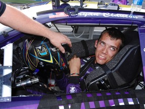 In this Oct. 4, 2007, file photo, Bryan Clauson smiles in his car during qualifying for the ARCA RE/MAX Series 250 auto race, at Talladega Superspeedway in Talladega, Ala. Clauson, considered the top dirt-track racer in the country, has died from injuries suffered in an accident at the Belleville (Kansas) Midget Nationals USAC midget race. He was 27. (AP Photo/Rainier Ehrhardt, File)