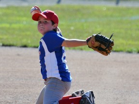 Jack Miller, even while on his knees, throws the ball to first base during action from the WOBA Major Rookie Tier 1 championship tournament at Keterson Park last Saturday morning, Aug. 6. The Astros won 14-4 but were ousted in the semi-finals Sunday. GALEN SIMMONS MITCHELL ADVOCATE