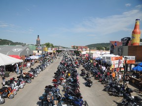 In this Aug. 5, 2015, file photo, motorcycles stretch down Main Street in Sturgis, S.D., for the landmark Sturgis Motorcycle Rally. Officials are expecting a smaller and quieter rally than last year's 75th anniversary event, which drew record crowds. The 76th rally in western South Dakota's Black Hills is Aug. 8-14, 2016. (AP Photo/James Nord, File)