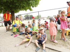 Eating some Freezies during the hot weather, some of the employees from Public works took a break with the daycare children.(Shaun Gregory/Huron Expositor)