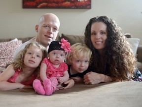 In this Sept. 1, 2014, photo, Willow Short, 4-month-old, center, along with her parents Megan and Mark and sister Liana, 6, and brother Mark, 3, poses for a photo in Sinking Spring, Pa. Willow Short had a heart transplant at 6-days-old. The couple featured in news stories about their difficulties getting medication for the daughter who had a heart transplant were found shot to death in their home along with their three children in apparent murder-suicide, authorities said Sunday, Aug. 7, 2016. (Susan L. Angstadt/Reading Eagle via AP)