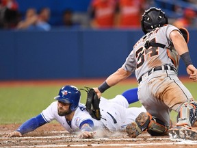 Toronto Blue Jays outfielder Kevin Pillar slides into home plate but is called out as Detroit Tigers catcher James McCann applies the tag in Toronto on Thursday, July 7, 2016. (THE CANADIAN PRESS/Frank Gunn)