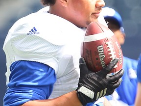 Winnipeg Blue Bombers offensive lineman Manase Foketi holds the ball during CFL football practice in Winnipeg, Man. Monday August 08, 2016.