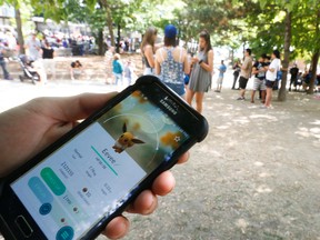 Jason Melo of Toronto plays Pokemon Go at the Jack Layton ferry terminals on Sunday. (JACK BOLAND, Toronto Sun)