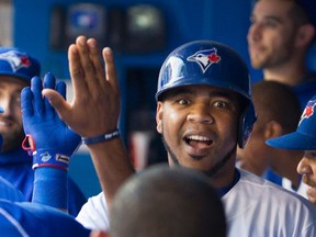 Toronto Blue Jays slugger Edwin Encarnacion is congratulated by teammates after hitting a home run against the Tampa Bay Rays in Toronto on Monday, August 8, 2016. (THE CANADIAN PRESS/Fred Thornhill)
