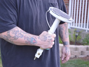 Tim Ranger holds the lamp he used to confront an intruder on Saturday night at his New Sudbury home. Ranger also struck the intruder with the lid of a toilet tank and butt end of a buck knife to protect his two young children. (Jim Moodie/Sudbury Star/Postmedia Network)