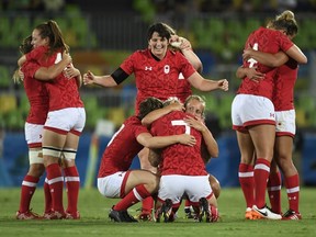 Canada's players, including Napanee's Brittany Benn (centre), celebrate victory in the women's rugby sevens bronze medal match between Canada and Great Britain during the Rio 2016 Olympic Games at Deodoro Stadium in Rio de Janeiro on Monday. (John Macdougall/Getty Images)