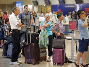 Delta passengers stand in line as the carrier slogged through day two of its recovery from a global computer outage Tuesday, Aug. 9, 2016, in Salt Lake City. (AP Photo/Rick Bowmer)