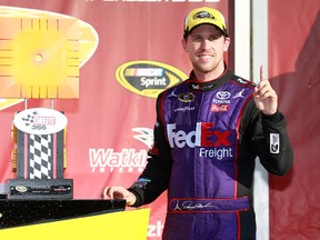 Denny Hamlin, driver of the #11 FedEx Freight Toyota, celebrates in victory lane after winning the NASCAR Sprint Cup Series Cheez-It 355 at Watkins Glen International on August 7, 2016 in Watkins Glen, New York. (Matt Sullivan/Getty Images)