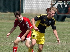 Wallaceburg Strikers 'B' player Carter Dekoning, right, fights for the ball against a Woodstock player during a Western Ontario Soccer League Fourth Division game at Kinsmen Park on  Sunday.  Wallaceburg won 1-0, with Bryer Genyn scoing the game's only goal. Rob Kraayenbrink had the shutout.