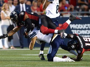 Ottawa Redblacks linebacker Damaso Munoz (45) falls over Toronto Argonauts ball carrier Devon Wylie (11) as he tries to make the tackle in Ottawa on Sunday, July 31, 2016. (THE CANADIAN PRESS/Justin Tang)