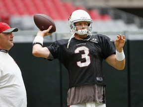 Arizona Cardinals quarterback Carson Palmer (3) warms up as QBs coach Freddie Kitchens, left, watches during practice Tuesday, Aug. 9, 2016, in Glendale, Ariz. (AP Photo/Ross D. Franklin)