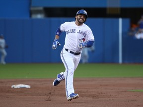 Devon Travis of the Toronto Blue Jays races to third base as he legs out a triple in the first inning in his team's game against the Tampa Bay Rays on August 8, 2016 at Rogers Centre in Toronto. (TOM SZCZERBOWSKI/Getty Images)