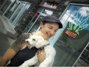 Jordan Chambers with her dog Fyn outside Weeds Glass & Gifts pot dispensary on Montreal Road in Ottawa